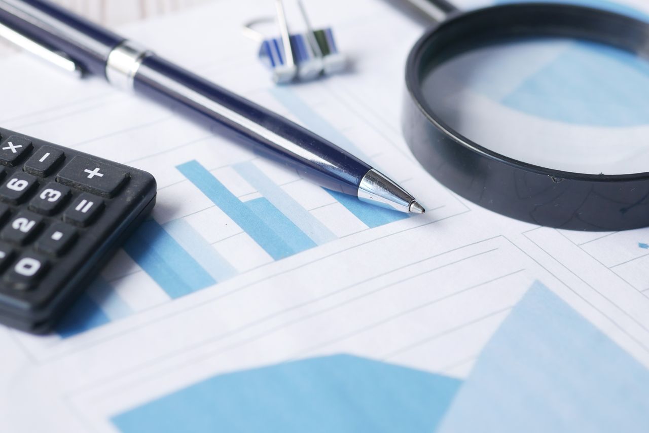 Mastering the First Impression: Your intriguing post title goes here Close-up of calculator, pen, and magnifying glass on financial documents.